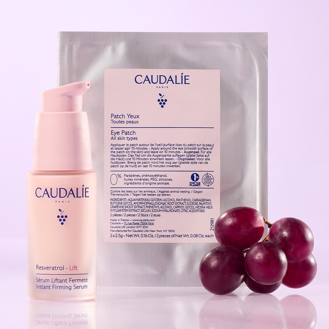 Caudalie skincare products including eye patches, instant firming serum, and resveratrol lift displayed with fresh grapes on a pink background.