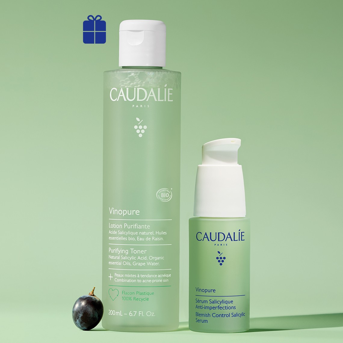 Caudalie Vinopure skincare set with purifying toner and salicylic serum on green background with gift icon and grape.