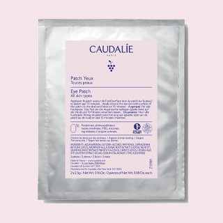 Caudalie eye patch sheet mask in silver foil packaging on pink background